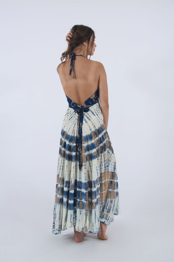 Model wearing our open back dress with halter neck. A flowy summer dress with tie dye print in blue and cream shades.